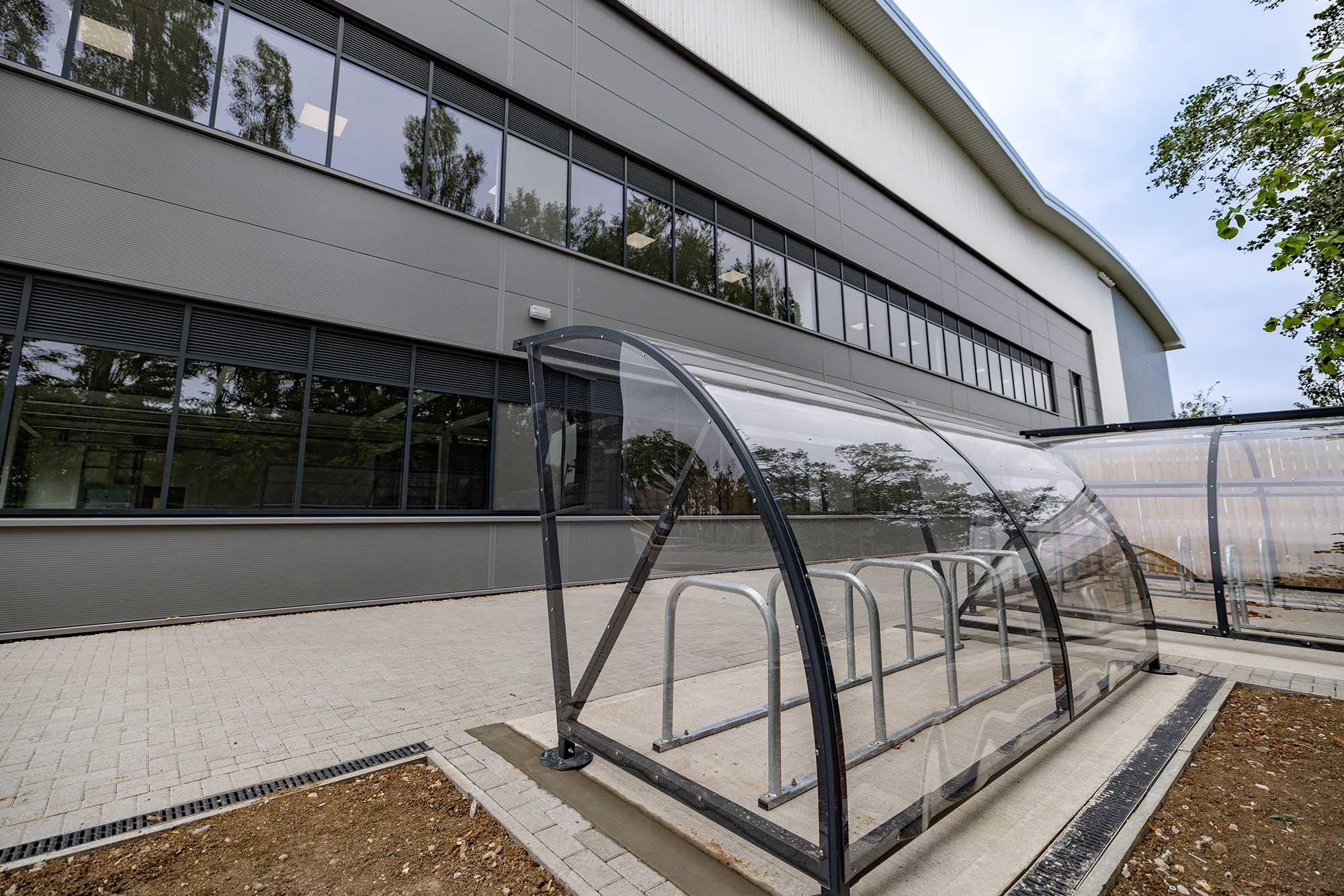 Covered cycle shelter alongside the office elevation