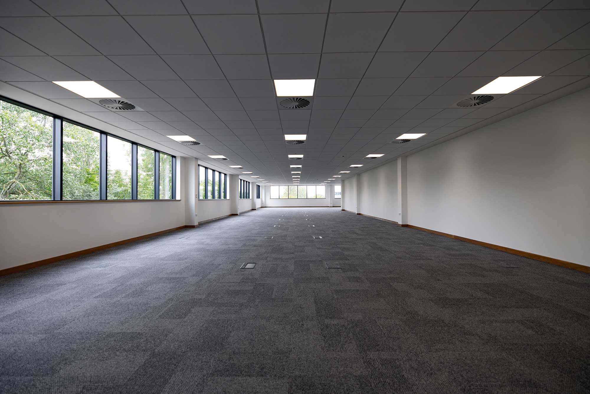 Open plan office interior with full height windows